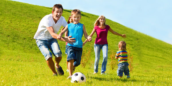 Parents-with-children-playing-football-Stock-Photo