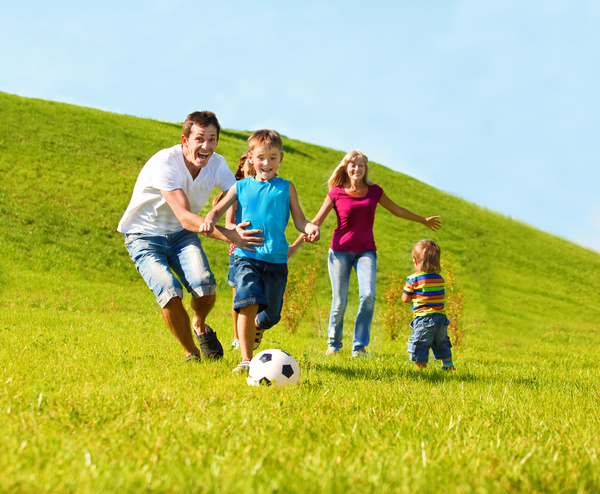 Parents-with-children-playing-football-Stock-Photo